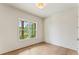 Bright bedroom with hardwood floors and a large window that offers ample natural light at 1005 Liberty Springs Dr, Woodstock, GA 30188