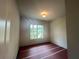 Neutral bedroom featuring a large window, neutral walls, and wood-look floor at 1005 Liberty Springs Dr, Woodstock, GA 30188