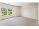 Bright, spacious bedroom with a large window overlooking the lush yard at 1005 Liberty Springs Dr, Woodstock, GA 30188