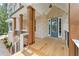 Inviting front porch with wooden floors and columns, offering curb appeal at 1005 Liberty Springs Dr, Woodstock, GA 30188