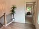 Hallway with a potted plant that leads to a bedroom with neutral walls and carpeted floor at 1005 Liberty Springs Dr, Woodstock, GA 30188