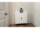 Hallway nook featuring a white cabinet with decorative vase, complemented by rich hardwood flooring at 1005 Liberty Springs Dr, Woodstock, GA 30188
