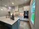 Gourmet kitchen featuring an island with seating, stainless steel appliances, and elegant pendant lighting at 1005 Liberty Springs Dr, Woodstock, GA 30188