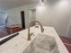 Kitchen island with light countertops and brass faucet against a backdrop of a new home being built at 1005 Liberty Springs Dr, Woodstock, GA 30188