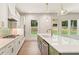 Bright, modern kitchen featuring stainless steel appliances and a large island with sink at 1005 Liberty Springs Dr, Woodstock, GA 30188