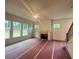 Bright living room featuring large windows, fireplace with mantle, and a ceiling fan at 1005 Liberty Springs Dr, Woodstock, GA 30188