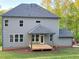 Rear exterior showcasing a gray siding with a covered patio and wooden deck at 1005 Liberty Springs Dr, Woodstock, GA 30188