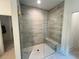 Modern tiled walk-in shower with glass enclosure and built-in bench at 1005 Liberty Springs Dr, Woodstock, GA 30188