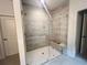 Glass enclosed shower with a built in bench at 1005 Liberty Springs Dr, Woodstock, GA 30188