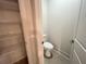 A toilet room includes a toilet and shelfing at 1005 Liberty Springs Dr, Woodstock, GA 30188