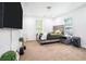 Bright bedroom featuring neutral carpet, rustic wood bed frame, and a large television for entertainment at 4135 Brenda Dr, Decatur, GA 30035