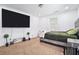 A cozy bedroom with a large television, neutral carpet, and simple decor for comfortable living at 4135 Brenda Dr, Decatur, GA 30035