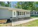 View of the home with a long sidewalk and green lawn surrounded by mature trees at 4135 Brenda Dr, Decatur, GA 30035