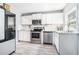 Modern kitchen with stainless steel appliances, white cabinets, and granite countertops at 4135 Brenda Dr, Decatur, GA 30035