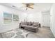 Bright living room with gray sofa, ceiling fan, and hardwood floors at 4135 Brenda Dr, Decatur, GA 30035