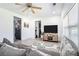 Bright living room with gray sofa, large TV, and hardwood floors at 4135 Brenda Dr, Decatur, GA 30035