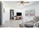 Bright living room with gray sofa, large TV, and hardwood floors at 4135 Brenda Dr, Decatur, GA 30035