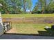 Backyard featuring a retaining wall with a wrought iron fence and mature trees at 4316 Sw Notting Hill Sw Dr, Atlanta, GA 30331