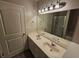 Bathroom featuring double sinks, modern lighting, and a glass-enclosed shower at 4316 Sw Notting Hill Sw Dr, Atlanta, GA 30331