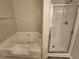 Bathroom showcasing a soaking tub and separate glass-enclosed shower at 4316 Sw Notting Hill Sw Dr, Atlanta, GA 30331