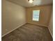 Comfortable bedroom featuring soft neutral carpeting and plenty of natural light at 4316 Sw Notting Hill Sw Dr, Atlanta, GA 30331