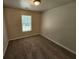 Bedroom features neutral walls, plush carpet, and a window overlooking the backyard at 4316 Sw Notting Hill Sw Dr, Atlanta, GA 30331