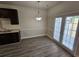 Dining area with hardwood floors, modern lighting, and French doors leading to the yard at 4316 Sw Notting Hill Sw Dr, Atlanta, GA 30331