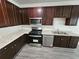Modern kitchen featuring stainless steel appliances, granite countertops, and dark wood cabinets at 4316 Sw Notting Hill Sw Dr, Atlanta, GA 30331