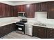 Updated kitchen features dark wood cabinetry, stainless appliances, and light countertops at 4316 Sw Notting Hill Sw Dr, Atlanta, GA 30331