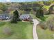 Expansive aerial view of estate home with long driveway, pond, and lush green lawn at 4790 Hyde Rd, Cumming, GA 30040
