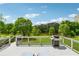 Spacious back deck with grill, lounge chairs, and scenic view of the pond and lawn at 4790 Hyde Rd, Cumming, GA 30040