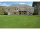 Expansive backyard with a two-story deck, lush lawn, and mature trees for privacy at 4790 Hyde Rd, Cumming, GA 30040