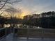 Backyard deck overlooking a serene pond and a beautiful forest at sunset at 4790 Hyde Rd, Cumming, GA 30040