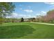 Spacious backyard with a long driveway and a beautiful home surrounded by mature trees at 4790 Hyde Rd, Cumming, GA 30040