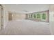 Large finished basement with multiple windows, plush carpet, and plenty of natural light at 4790 Hyde Rd, Cumming, GA 30040