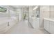 Bright bathroom featuring double sinks, gold fixtures, and separate tub and shower at 4790 Hyde Rd, Cumming, GA 30040