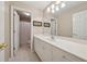 Bright bathroom with double vanity, neutral tile flooring, and a large mirror at 4790 Hyde Rd, Cumming, GA 30040