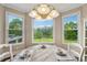 Bright breakfast nook with large windows offering backyard views and stylish lighting at 4790 Hyde Rd, Cumming, GA 30040