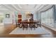 Formal dining room with wainscoting, hardwood floors, and elegant chandelier at 4790 Hyde Rd, Cumming, GA 30040