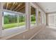 Lower level windows showcasing a walkout patio and peaceful green lawn with a pond view at 4790 Hyde Rd, Cumming, GA 30040
