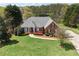 Beautiful front yard with lush landscaping, blooming azaleas, and a well-maintained lawn at 4790 Hyde Rd, Cumming, GA 30040