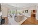 Bright living room with large windows, hardwood floors, fireplace, and custom built-ins at 4790 Hyde Rd, Cumming, GA 30040