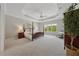 Inviting bedroom with a tray ceiling, a large window view, and neutral decor at 4790 Hyde Rd, Cumming, GA 30040