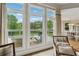 Bright sunroom with large windows offering scenic views and access to a deck at 4790 Hyde Rd, Cumming, GA 30040