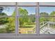 Picturesque backyard view of mature trees and a serene lake from a large window at 4790 Hyde Rd, Cumming, GA 30040