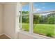 Close-up of a bright window with a view of a green backyard and a serene lake at 4790 Hyde Rd, Cumming, GA 30040