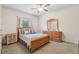 Comfortable bedroom with wood furniture, fan, and neutral decor at 4459 Sierra Creek Dr, Hoschton, GA 30548