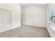 Empty bedroom featuring carpet, a window, and a vaulted ceiling at 4459 Sierra Creek Dr, Hoschton, GA 30548