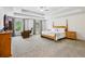 Spacious primary bedroom with tray ceiling, carpet, ceiling fan, and an office space at 4459 Sierra Creek Dr, Hoschton, GA 30548