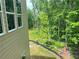 View of the backyard and woods beyond the side of the house at 1025 Liberty Springs Dr, Woodstock, GA 30188